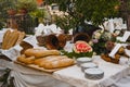 Beautiful Italian garden feast table with freshly baked loaves of bread, fruit and flowers Royalty Free Stock Photo