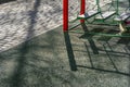 Outdoor Kids Playground Area, Paved Walkway in the Park on a Spring Afternoon with Long Shadows