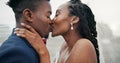 Outdoor, kiss and black couple with marriage, wedding and hug with happiness, romance and celebration. African man