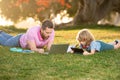 Outdoor learning. Blogging. Happy father using laptop relax with schooler son holding laptop. Childhood and parenthood