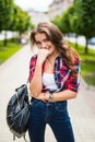 Outdoor lifestyle portrait of amazing glamorous luxury woman posing in city center