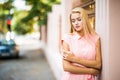 Outdoor lifestyle portrait of amazing glamorous luxury woman posing in city street.