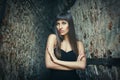 Outdoor lifestyle portrait of pretty young girl posing between walls, wearing in fashion style on urban background. Creative toned