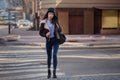 Outdoor lifestyle portrait of pretty young girl, wearing in hipster swag grunge style on urban background. Wearing hat and jeans Royalty Free Stock Photo