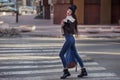 Outdoor lifestyle portrait of pretty young girl, wearing hipster swag grunge style on urban background. Wearing hat and jeans with Royalty Free Stock Photo