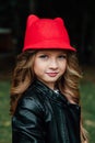 Outdoor lifestyle portrait of stylish little girl teenager on city park. . Beautiful child, wearing. Royalty Free Stock Photo