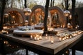 Outdoor lounge area for a wedding with sofas on a wooden terrace, decorated with white flowers and candles