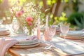 Outdoor lunch table setting with flowers. Romantic table setting with tablecloth, plates, crystal goblets, beautiful Royalty Free Stock Photo