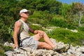 Outdoor man resting on rock after hiking Royalty Free Stock Photo