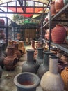 Outdoor market with metal racks of Mexican pottery and chimeneas