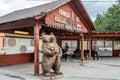 Outdoor Market Offer Honey and Cheese Under a Wooden Kiosk in Croatian Countryside. Big Bear Carved Statue Holding Jars in Front