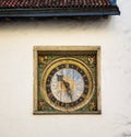Outdoor medieval clock on the wall of the church of the Holy Ghost in Tallinn, Estonia