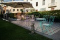 Mediterranean Garden Patio With Tables, Chairs and Umbrella