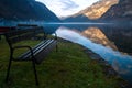 Outdoor natural park benches with mountain lake view reflecting on water surface, HallstÃÂ¤tter Lake in Salzkammergut, Austria Royalty Free Stock Photo