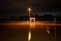 Outdoor night scenery view of flooded area along promenade riverside of Rhine river.