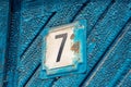 Outdoor old blue door with number seven Royalty Free Stock Photo