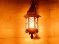 Outdoor old vintage lamp light glowing in the dark. Beautiful dusty lantern hang in front of house in the night Royalty Free Stock Photo