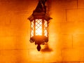 Outdoor old vintage lamp light glowing in the dark. Beautiful dusty lantern hang in front of house in the night Royalty Free Stock Photo