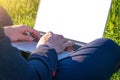 Outdoor online business technology. Student boy work with laptop tablet, computer in nature outside. Person man sitting in summer Royalty Free Stock Photo