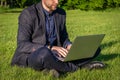 Outdoor online business technology. Student boy work with laptop tablet, computer in nature outside. Person man sitting Royalty Free Stock Photo