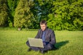 Outdoor online business technology. Student boy work with laptop tablet, computer in nature outside. Person man sitting Royalty Free Stock Photo