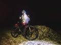 Outdoor orienteering extreme bike race in night. Woman check Royalty Free Stock Photo