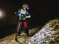 Outdoor orienteering extreme bike race in night. Woman check Royalty Free Stock Photo