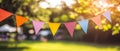 An outdoor party is characterized by fluttering strings of colorful pennant flags creating a festive and lively