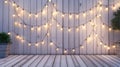 an outdoor party or event with a wooden fence adorned with string lights in the background, and a wooden stage, offering Royalty Free Stock Photo