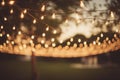 Outdoor party string lights hanging in backyard on bokeh background. Generative AI Royalty Free Stock Photo