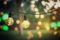 outdoor party string lights hanging in backyard on green bokeh background with copy space Royalty Free Stock Photo