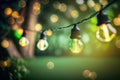 outdoor party string lights hanging in backyard on green bokeh background with copy space Royalty Free Stock Photo