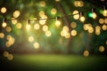 outdoor party string lights hanging in backyard on green bokeh background with copy space Royalty Free Stock Photo