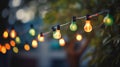 outdoor party string lights hanging in backyard on green bokeh background with copy space Royalty Free Stock Photo