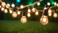 outdoor party string lights hanging in backyard on green bokeh background with copy space Royalty Free Stock Photo