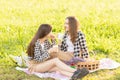 Outdoor party. Two young girls having fun, having fun on the grass Royalty Free Stock Photo