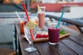 An outdoor patio bar top with a fruit platter, and glass drinks with food-grade, silicone straws Royalty Free Stock Photo