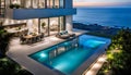 Outdoor patio and small pool in a modern residential building in the evening with lighting and ocean view,