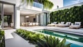 Outdoor patio and small pool in a modern residential building in the evening with lighting and ocean view,