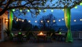 Outdoor patio with string lights at night, cozy evening setting Generative AI Royalty Free Stock Photo