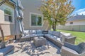 Outdoor patio with woven couch and arcmchair near the tree