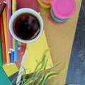 Outdoor photo of art working dekstop with colored felt pens, cup of coffee