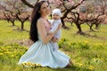 Mother with dark hair in elegant dress posing with her little cu Royalty Free Stock Photo
