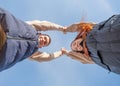 cheerful romantic couple dating and holding hands outdoors, sky background Royalty Free Stock Photo