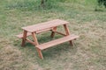 Outdoor picnic wooden table in park with green grass field enjoying sunny weekend summer day