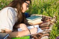 Outdoor picture of lovely girl with book