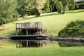 Outdoor platform and table overlooking a dam on a luxury country estate