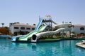 Outdoor pool with blue clear warm water and water slides pipes on vacation in a tropical warm exotic country, a seaside resort wit