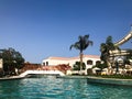 Outdoor pool with blue transparent warm water and water slides on vacation in a tropical warm exotic country, a seaside resort wit Royalty Free Stock Photo