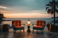 Outdoor pool lounge chairs and sunset over the ocean, summer landscape image Royalty Free Stock Photo